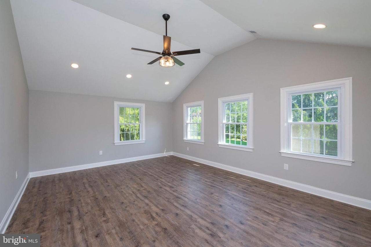 Chapel Ridge — bedroom with wood-look flooring and ceiling fan