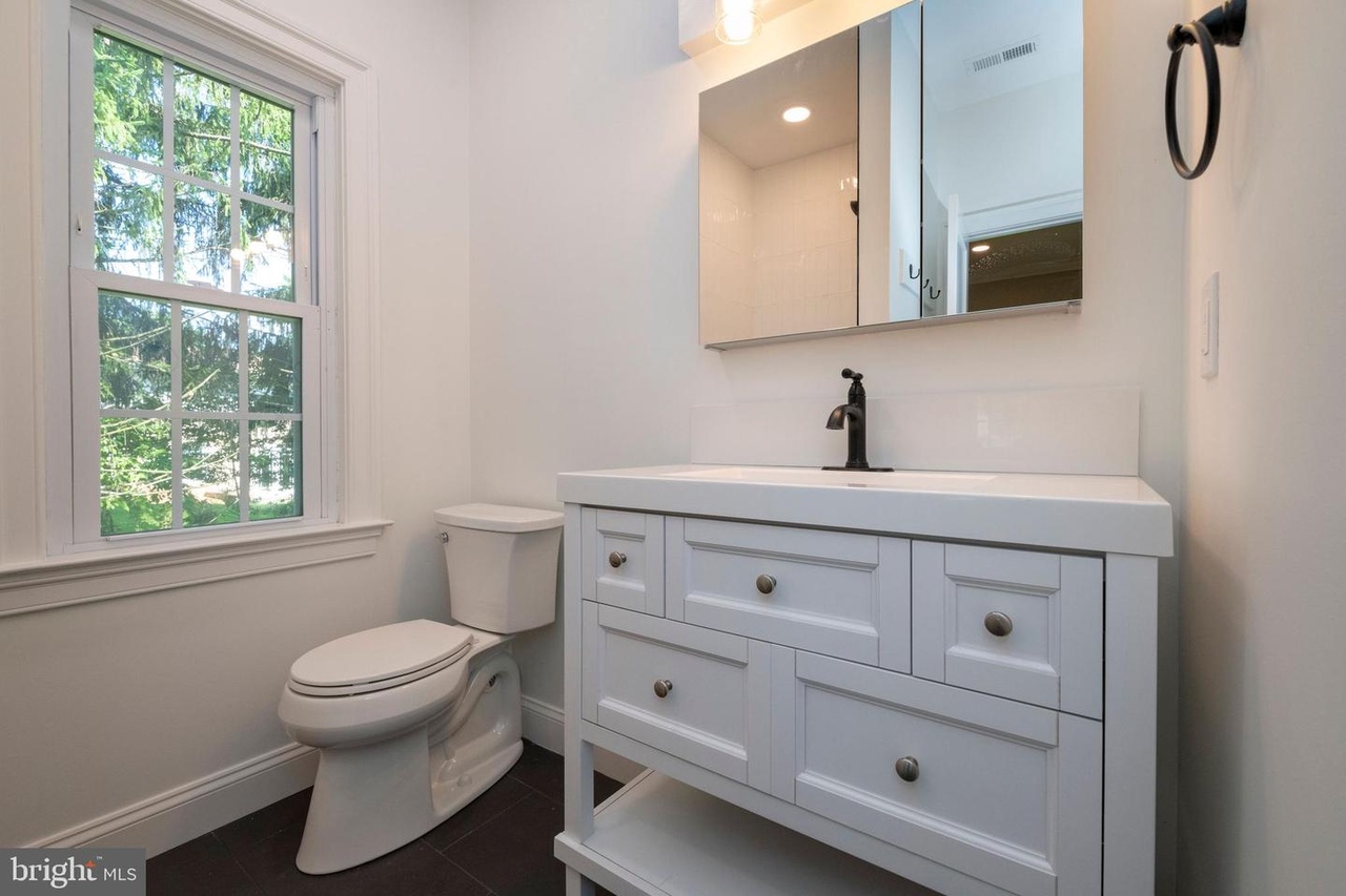 Chapel Ridge — bathroom vanity with dark fixtures and a window