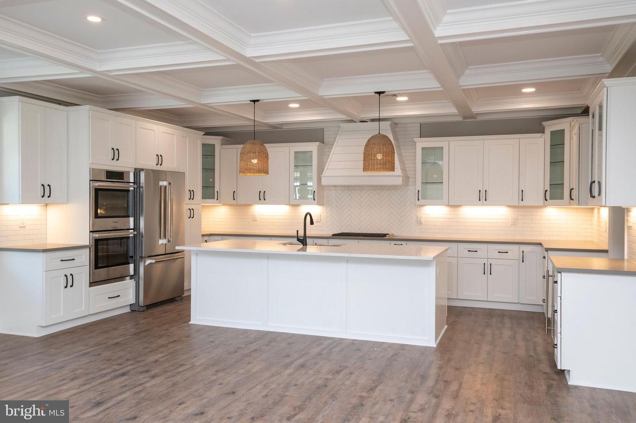 Chapel Ridge — kitchen with a white island, woven pendant lights and coffered ceiling