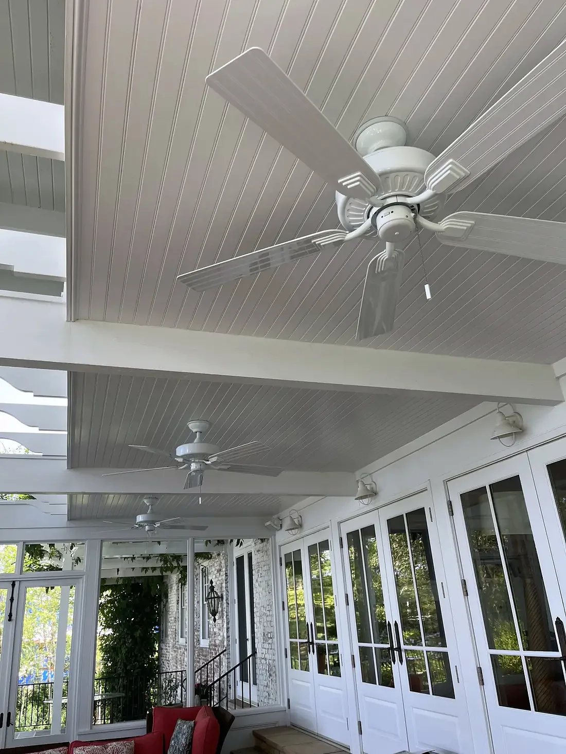 Screened porch with a beadboard ceiling and ceiling fan