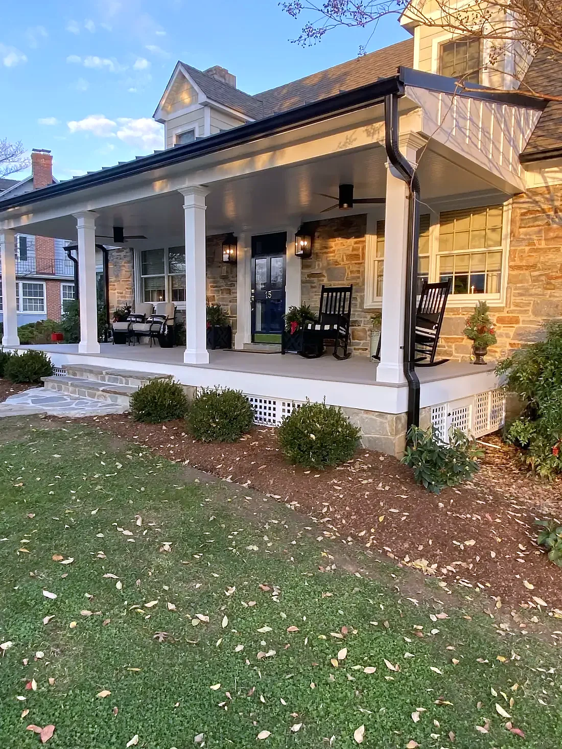 Stone farmhouse with a covered wraparound porch